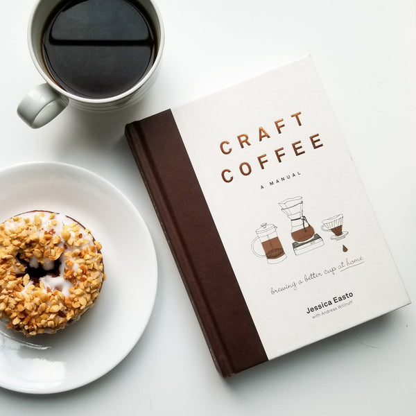 craft coffee hardback book by jessica easto with a donut and black coffee on white table